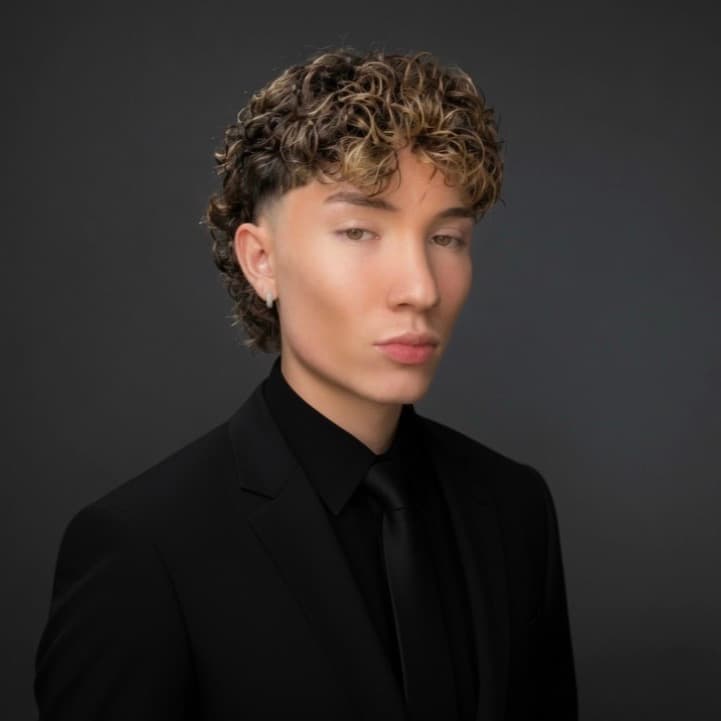 Trilly, the trader and educator behind TRADEwithTRILLY, in a black suit